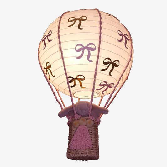Decorative baby nursery paper hot air balloon night light shade with bow patterns on a dark background
